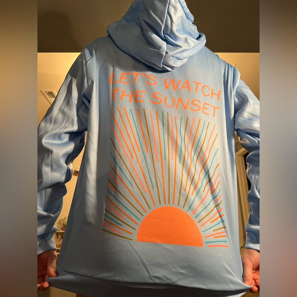 Light blue sweatshirt with orange let’s watch the sunset back